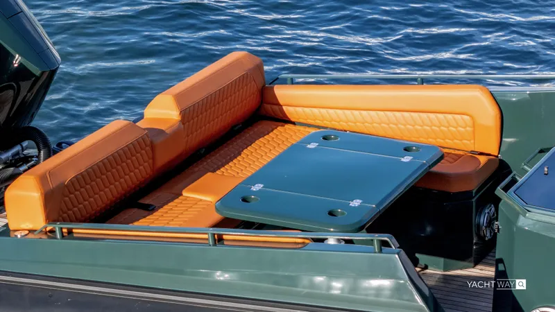 Slide: The Image of Luxurious seating area on 2025 Skipper-BSK 38 yacht with orange upholstery and green table. - 32