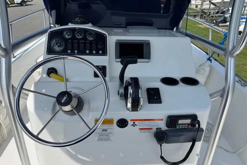 Slide: The Image of 2013 Boston Whaler 210 Montauk boat console with steering wheel and controls. - 14
