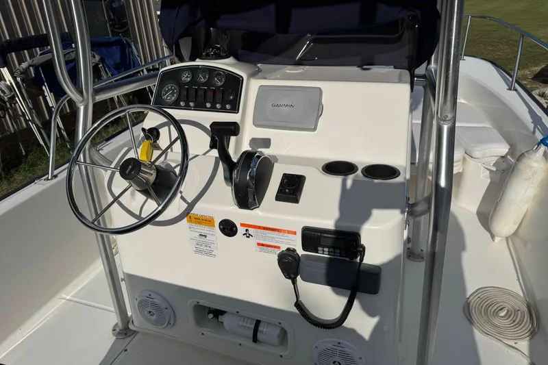 Slide: The Image of 2013 Boston Whaler 210 Montauk boat console with steering wheel and controls. - 15