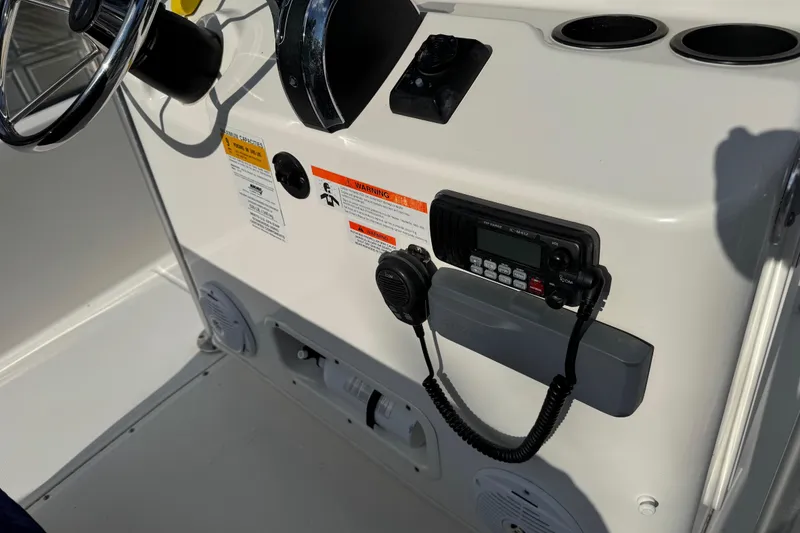 Slide: The Image of 2013 Boston Whaler 210 Montauk console with steering wheel and communication equipment. - 17