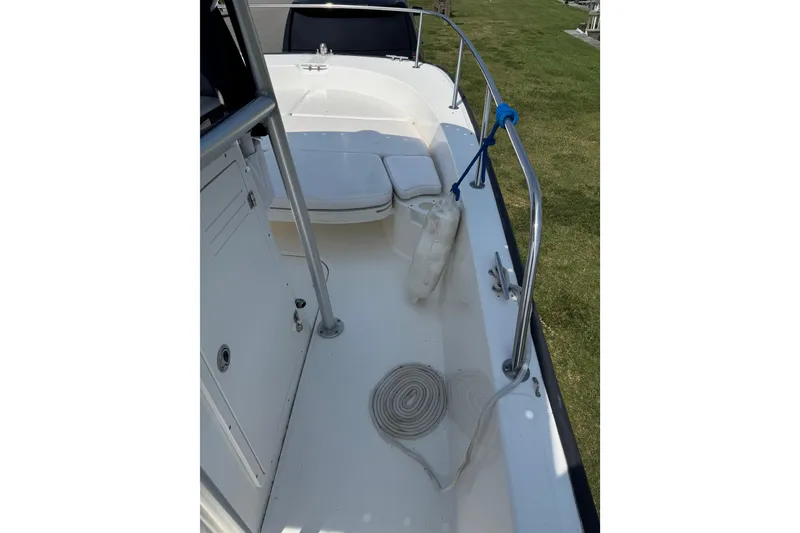 Slide: The Image of 2013 Boston Whaler 210 Montauk boat interior with seating and railing. - 24