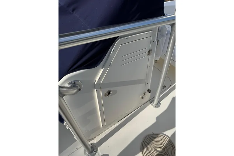 Slide: The Image of 2013 Boston Whaler 210 Montauk boat interior with storage compartment and railing. - 27