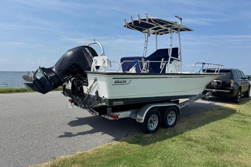 Slide: The Image of 2013 Boston Whaler 210 Montauk boat on trailer by the water. - 5