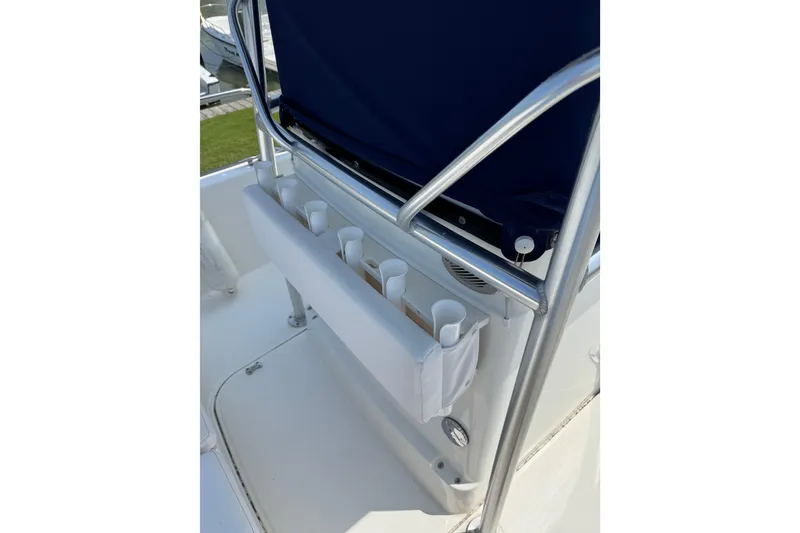 Slide: The Image of 2013 Boston Whaler 210 Montauk boat interior with rod holders and seating. - 9