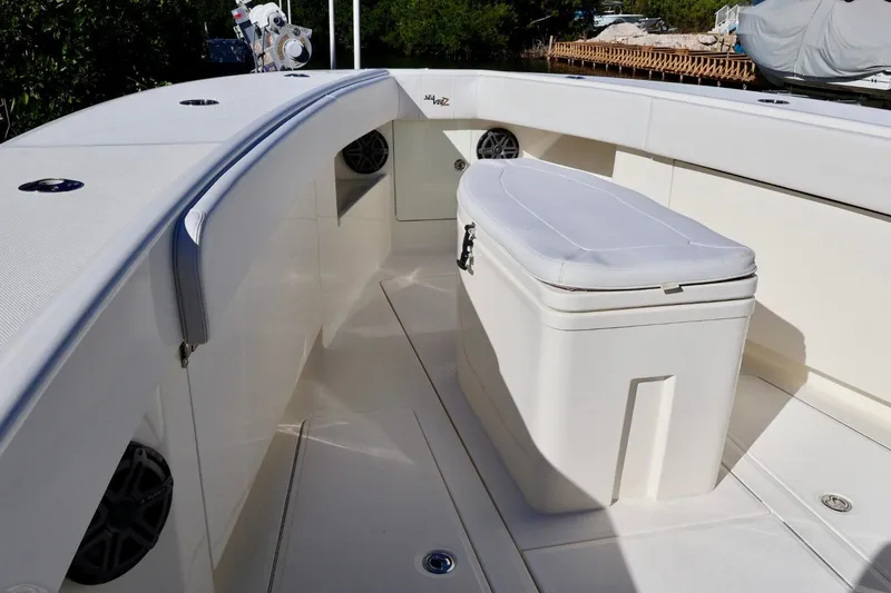 Slide: The Image of 2019 SeaVee 370Z boat interior with seating and storage, featuring sleek white design. - 12