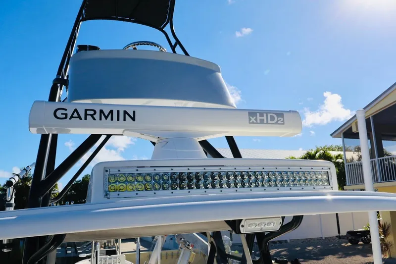 Slide: The Image of 2019 SeaVee 370Z boat with Garmin xHD2 radar and LED lights under clear blue sky. - 13
