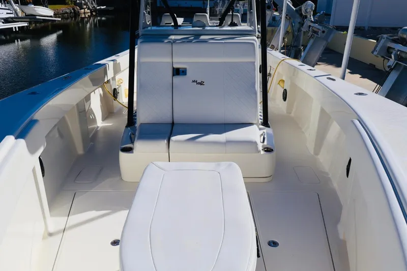 Slide: The Image of 2019 SeaVee 370Z boat interior with seating, docked by the water. - 14