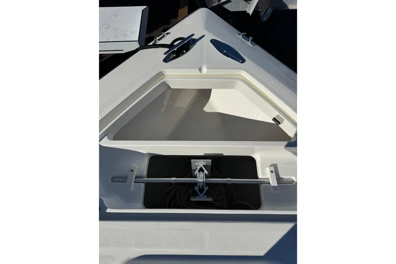 Slide: The Image of 2019 SeaVee 370Z boat storage compartment with open hatch and visible rope. - 17