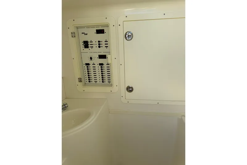 Slide: The Image of 2019 SeaVee 370Z control panel and storage compartment in cabin interior. - 18