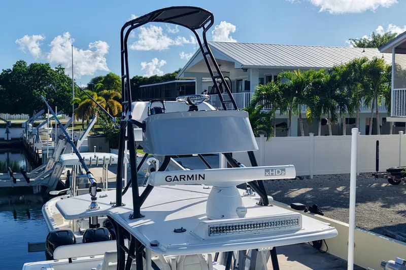 Slide: The Image of 2019 SeaVee 370Z boat with Garmin radar, docked near palm trees and houses. - 4