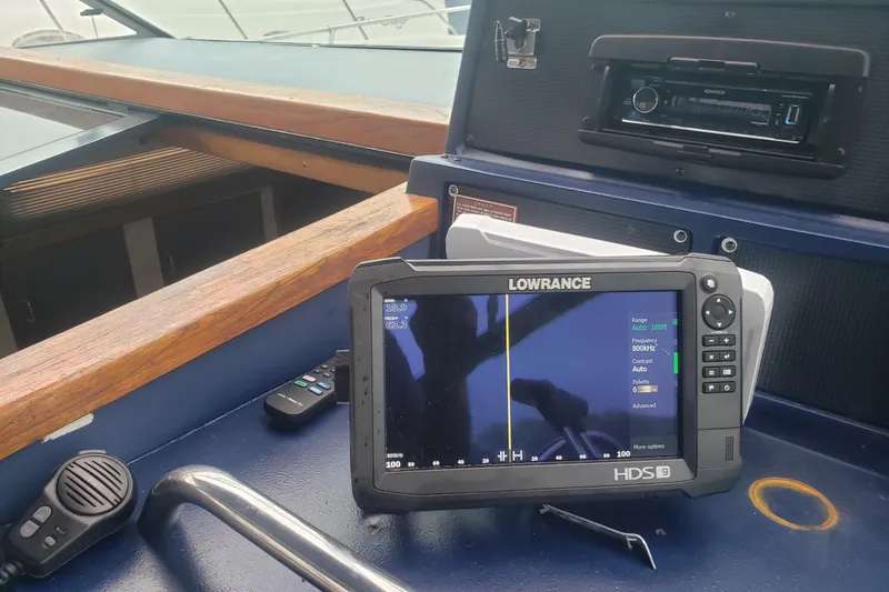 Slide: The Image of Control panel of a 1988 Sea Ray 390 Express Cruiser with Lowrance HDS display. - 19