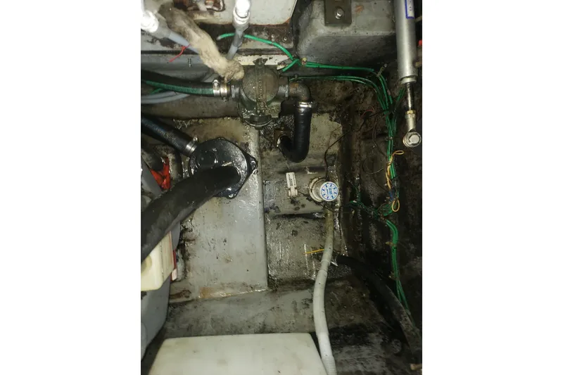 Slide: The Image of Engine compartment of a 1988 Sea Ray 390 Express Cruiser, showing hoses and wiring. - 26