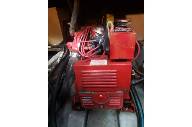 Slide: The Image of Engine compartment of 1988 Sea Ray 390 Express Cruiser with red machinery and cables. - 27