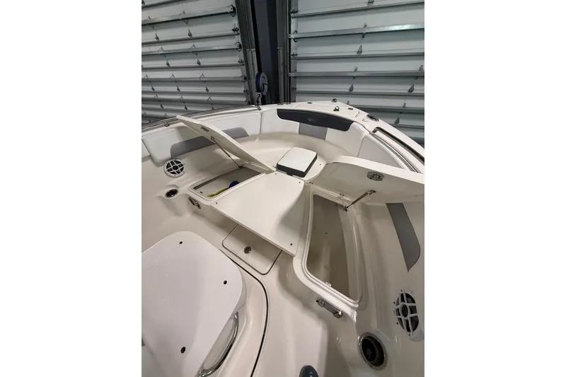 Slide: The Image of 2021 Robalo R222 Center Console boat interior with open storage compartments. - 11