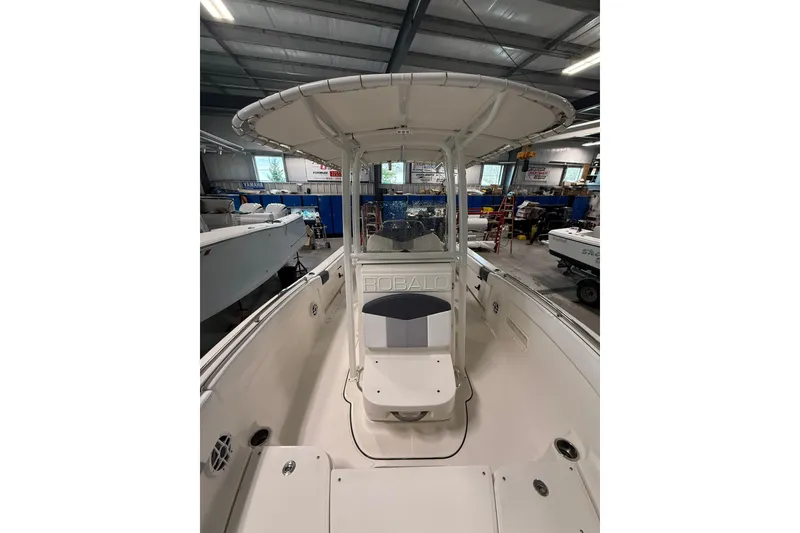 Slide: The Image of 2021 Robalo R222 Center Console boat in a showroom, showcasing interior and helm. - 12