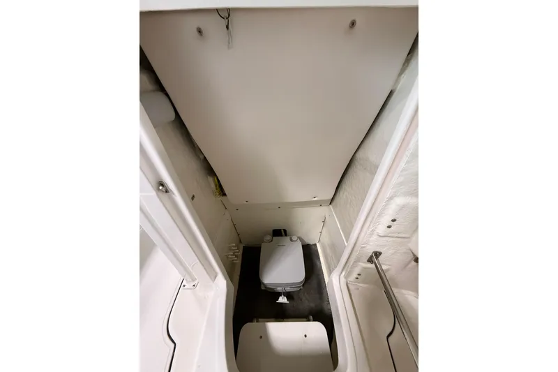 Slide: The Image of 2021 Robalo R222 Center Console interior with compact marine toilet. - 16
