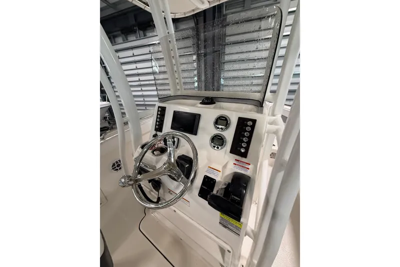 Slide: The Image of 2021 Robalo R222 Center Console dashboard with steering wheel and controls. - 17