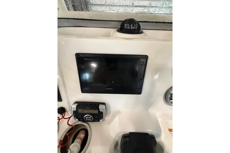Slide: The Image of 2021 Robalo R222 Center Console dashboard with Garmin GPS and compass. - 18