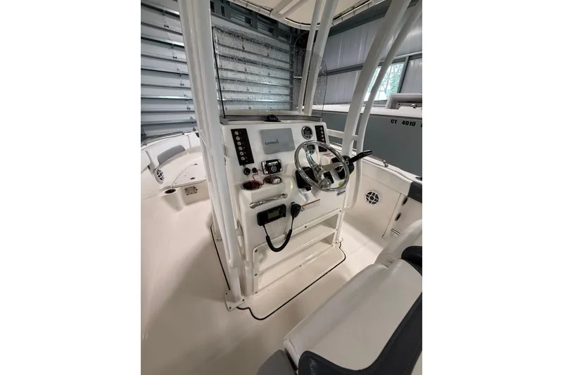 Slide: The Image of 2021 Robalo R222 Center Console boat interior with steering wheel and controls. - 19