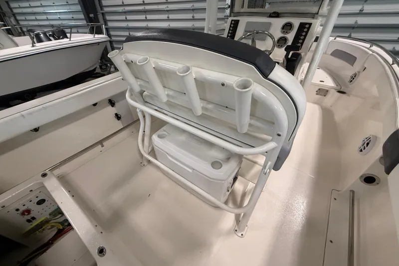 Slide: The Image of 2021 Robalo R222 Center Console boat interior with rod holders and storage. - 21
