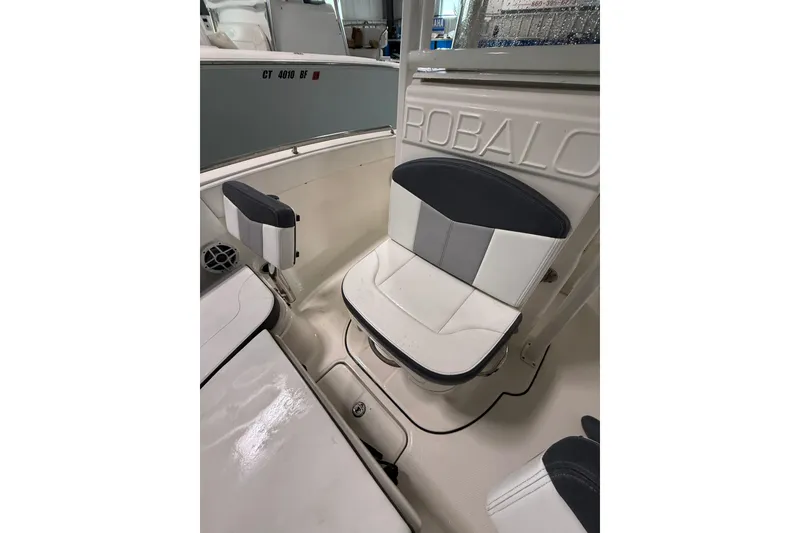 Slide: The Image of 2021 Robalo R222 Center Console boat interior with cushioned seating. - 24
