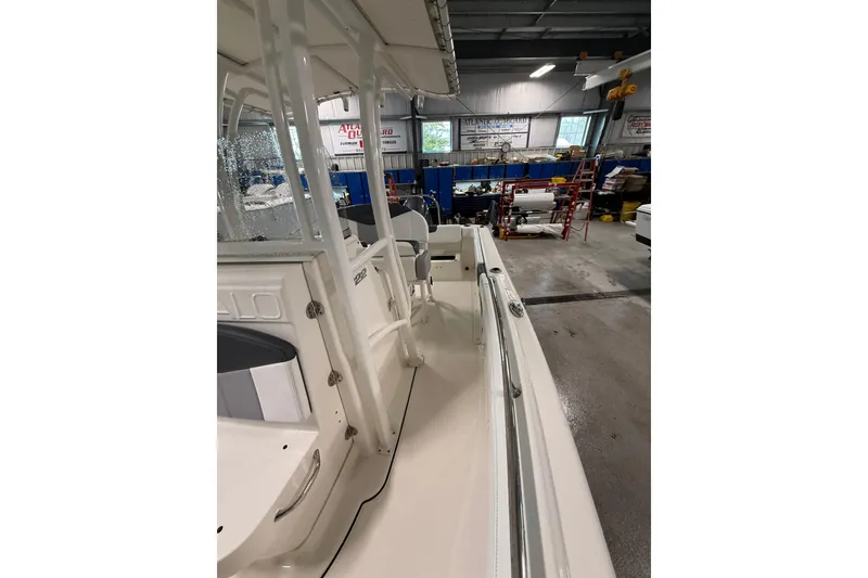 Slide: The Image of 2021 Robalo R222 Center Console boat in a workshop setting. - 25