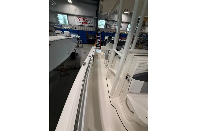 Slide: The Image of 2021 Robalo R222 Center Console boat in showroom, side view. - 26