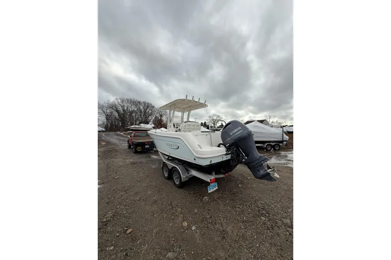 Slide: The Image of 2021 Robalo R222 Center Console boat on trailer, overcast sky background. - 5