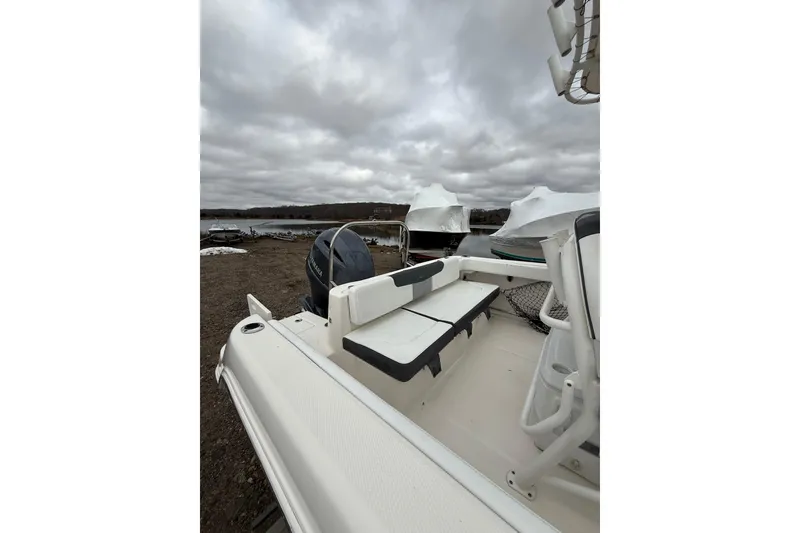 Slide: The Image of 2021 Robalo R222 Center Console boat with Yamaha engine, docked under cloudy skies. - 9