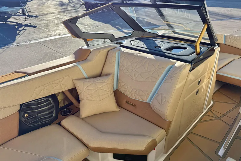 Slide: The Image of 2026 Nautique Super Air Nautique G25 Paragon interior with beige seating and geometric patterns. - 10