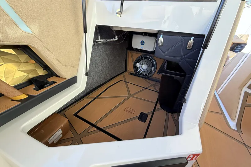 Slide: The Image of 2026 Nautique Super Air Nautique G25 Paragon interior storage with speaker and luxury finishes. - 17