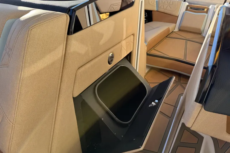 Slide: The Image of 2026 Nautique Super Air Nautique G25 Paragon interior with open storage compartment. - 18