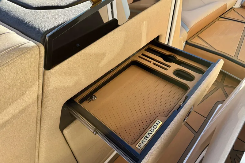 Slide: The Image of 2026 Nautique Super Air Nautique G25 Paragon interior with custom storage compartment. - 19