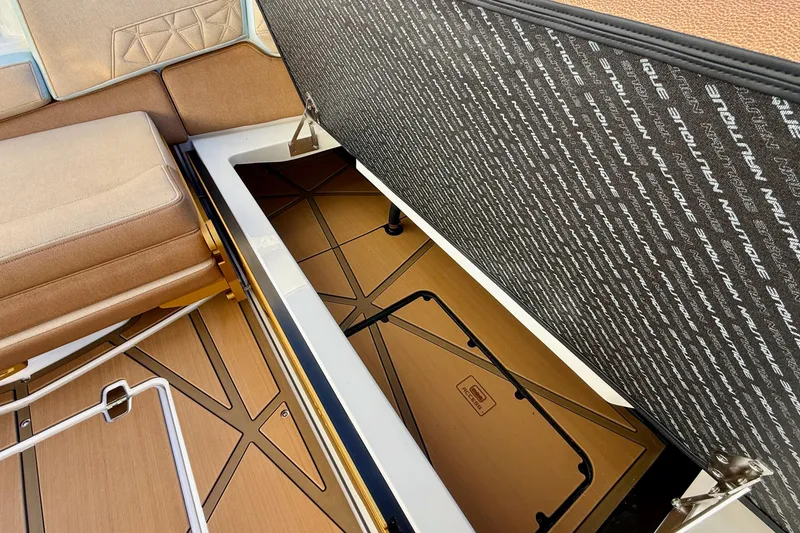 Slide: The Image of 2026 Nautique Super Air Nautique G25 Paragon interior storage compartment with cushioned seating. - 20