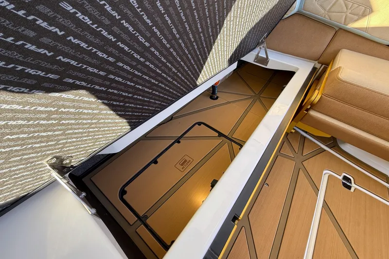 Slide: The Image of 2026 Nautique Super Air Nautique G25 Paragon interior storage compartment with cushioned seating. - 21