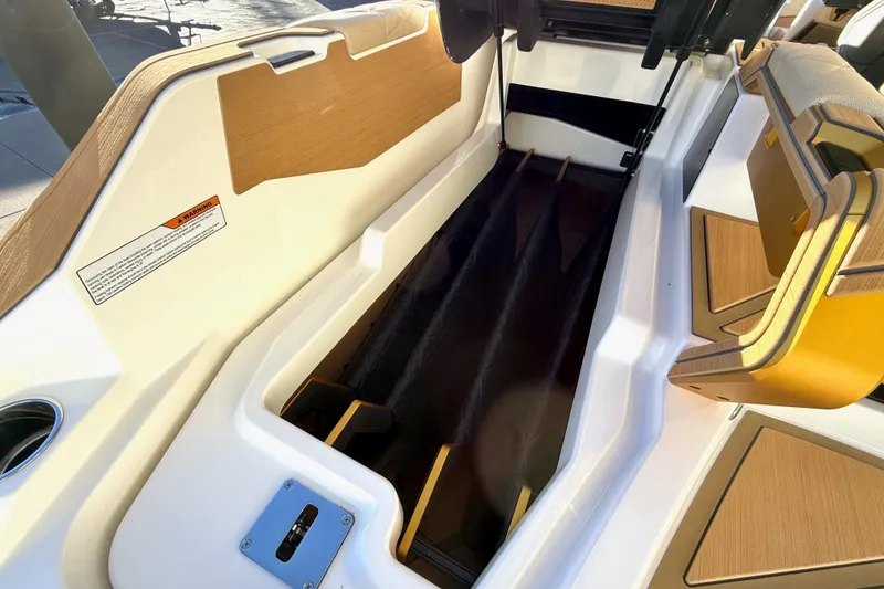 Slide: The Image of 2026 Nautique Super Air Nautique G25 Paragon interior with sleek seating and storage design. - 22
