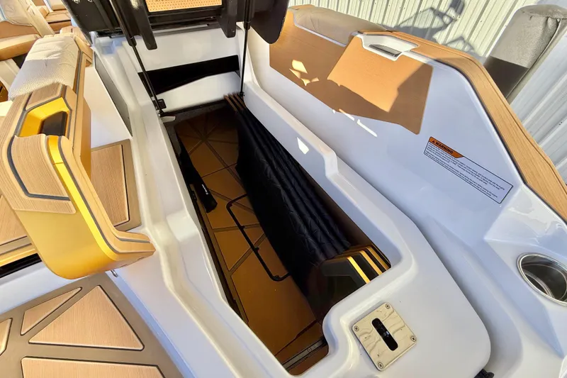 Slide: The Image of 2026 Nautique Super Air Nautique G25 Paragon interior storage compartment with luxury seating. - 23
