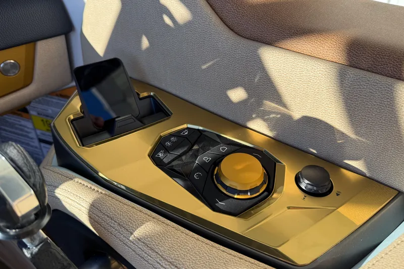 Slide: The Image of Control panel of 2026 Nautique Super Air Nautique G25 Paragon with sleek design and smartphone holder. - 28