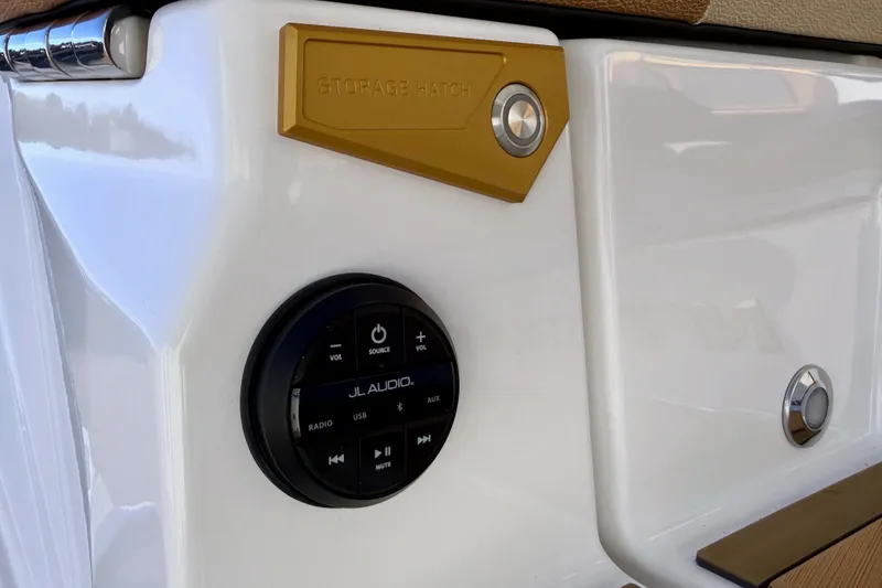 Slide: The Image of 2026 Nautique Super Air Nautique G25 Paragon audio controls and storage hatch detail. - 29