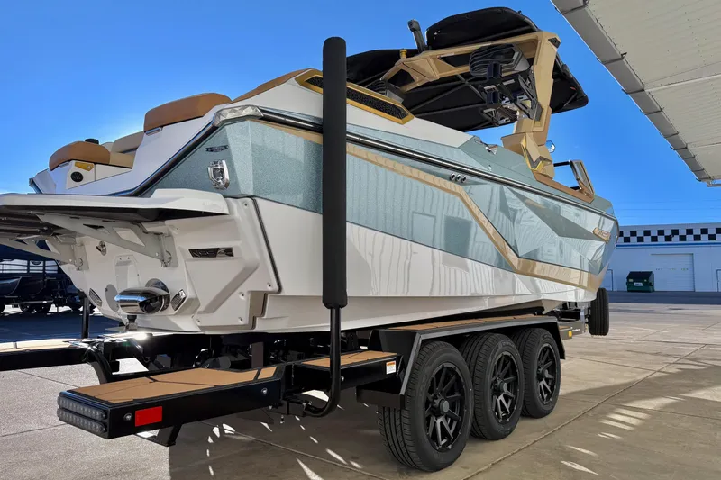 Slide: The Image of 2026 Nautique Super Air Nautique G25 Paragon boat on a trailer, side view. - 5