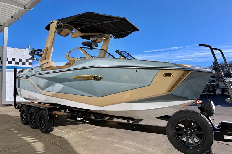 Slide: The Image of 2026 Nautique Super Air Nautique G25 Paragon boat on trailer under clear blue sky. - 7