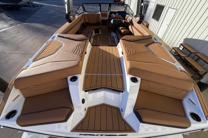Slide: The Image of 2026 Nautique Super Air Nautique G25 boat with luxurious tan seating and sleek design. - 11
