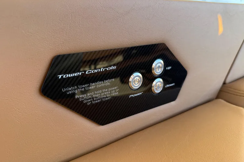 Slide: The Image of 2026 Nautique Super Air Nautique G25 tower controls on beige interior panel. - 15