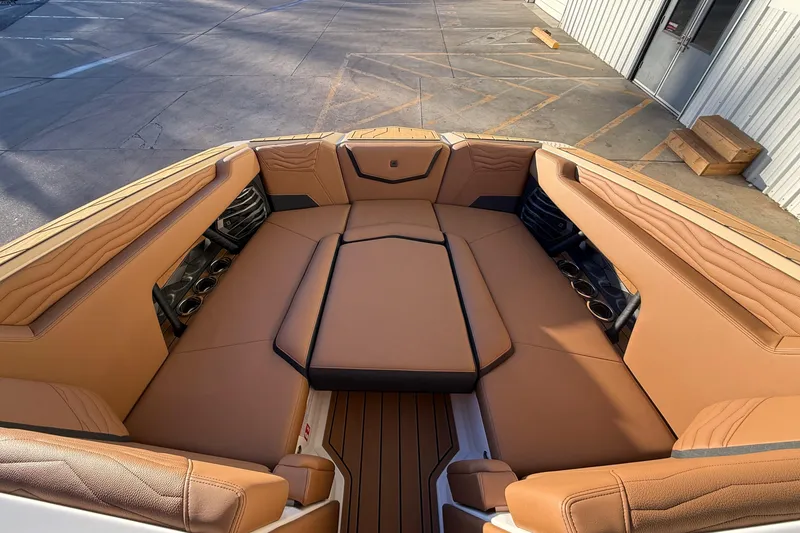 Slide: The Image of Luxurious interior of 2026 Nautique Super Air Nautique G25 boat with tan seating. - 16