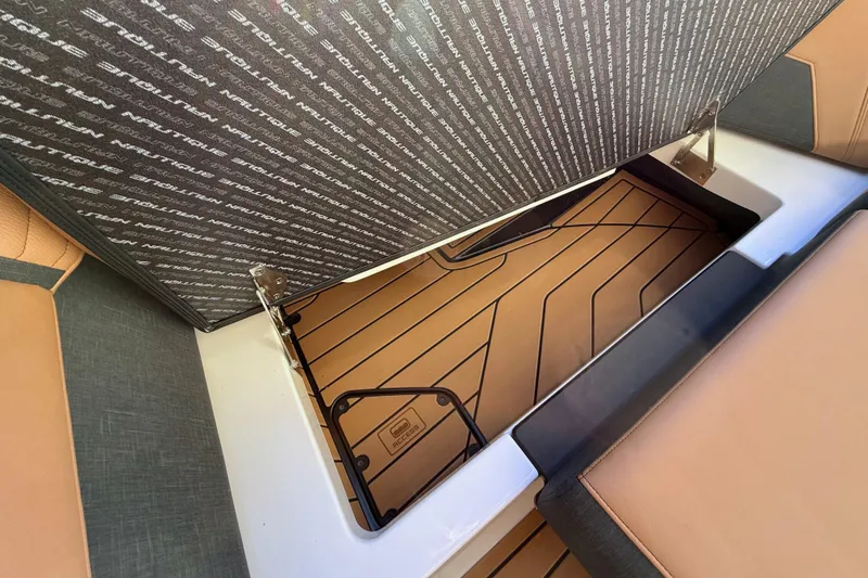 Slide: The Image of 2026 Nautique Super Air Nautique G25 storage compartment with stylish interior design. - 18