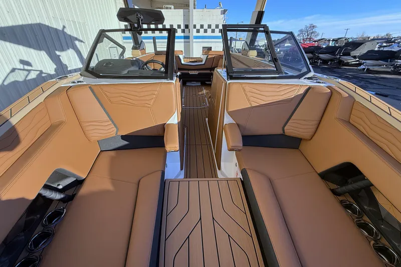 Slide: The Image of 2026 Nautique Super Air Nautique G25 interior with tan seating and sleek design. - 19