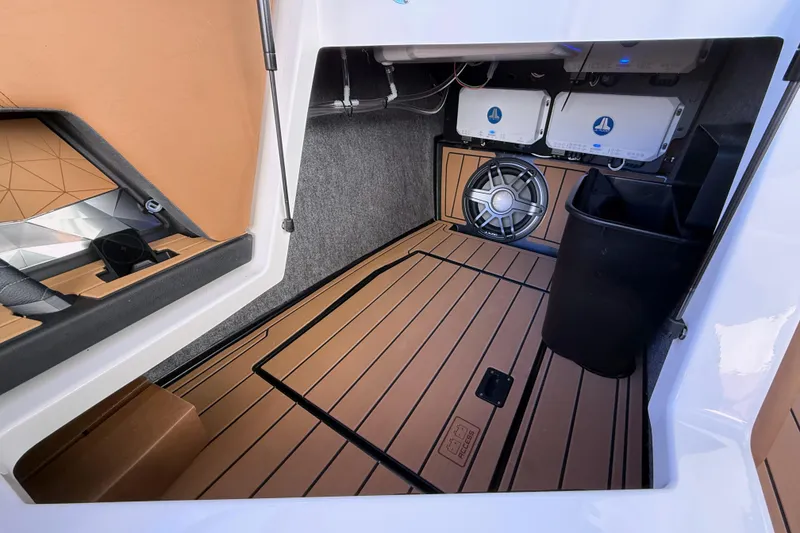 Slide: The Image of 2026 Nautique Super Air Nautique G25 interior storage with speaker and equipment. - 21