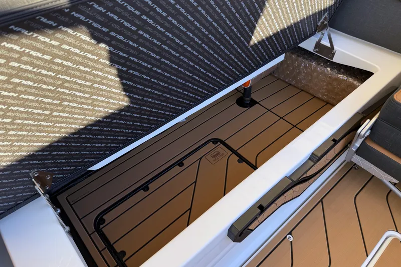 Slide: The Image of 2026 Nautique Super Air Nautique G25 storage compartment with branded interior design. - 23