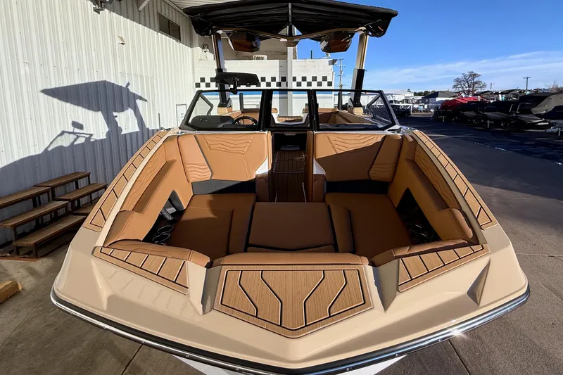 Slide: The Image of 2026 Nautique Super Air Nautique G25 boat with luxurious tan interior seating. - 3