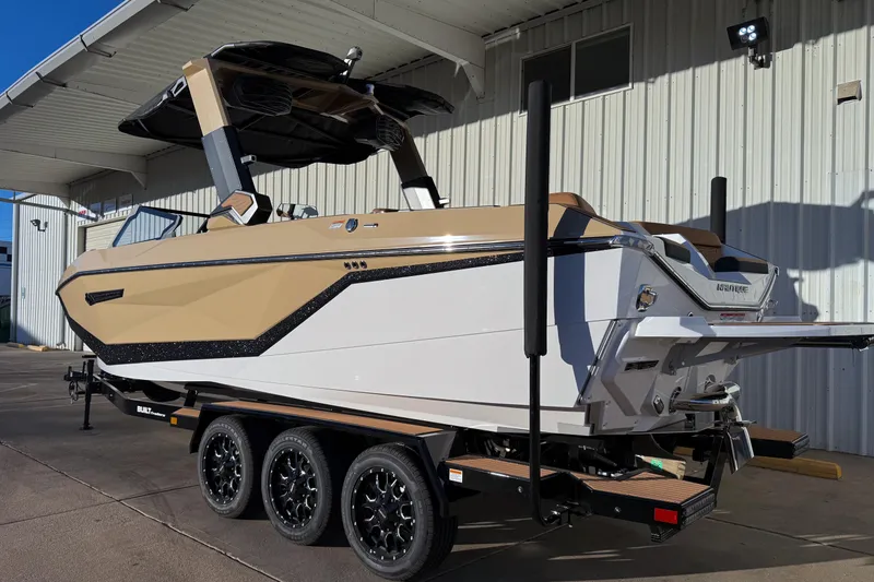 Slide: The Image of 2026 Nautique Super Air Nautique G25 boat on trailer, beige and white design. - 4